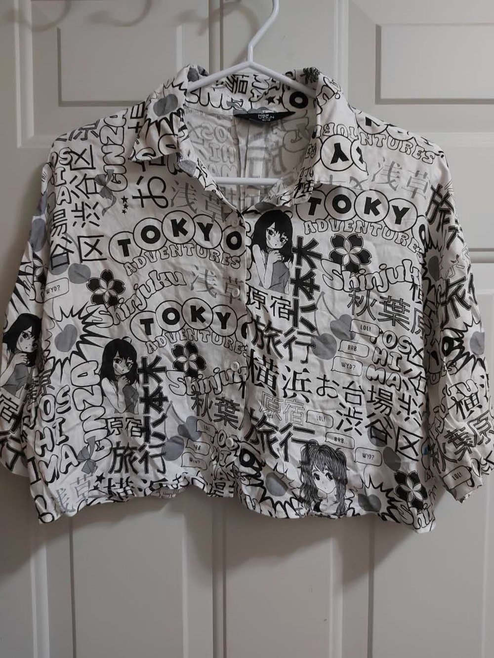 Black and white short sleeve button down crop top with anime print